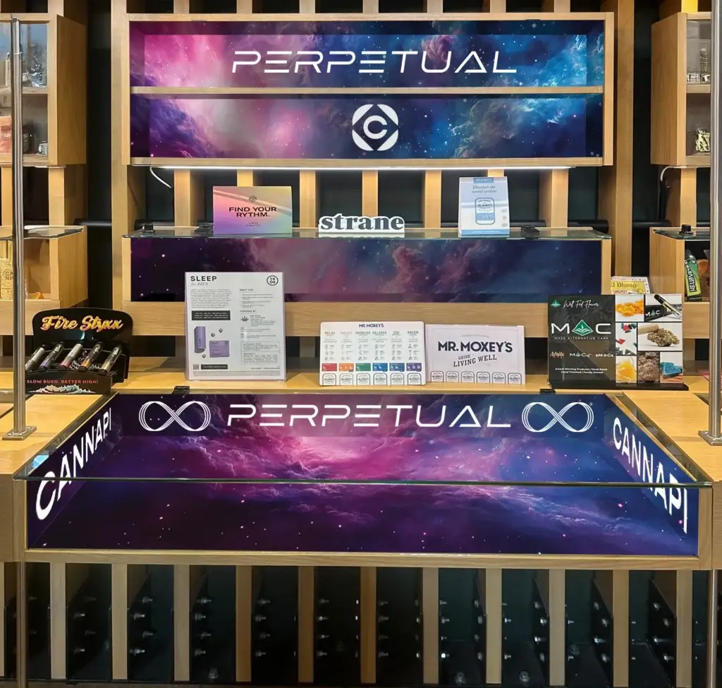 Perpetual counter wrap and shelf back-panel display installed at Cannapi dispensary