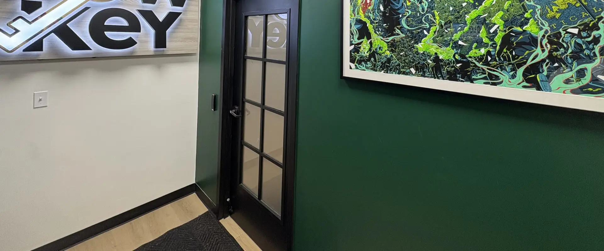 The Lowkey store interior: the dimensional sign wall beside the commissioned mural