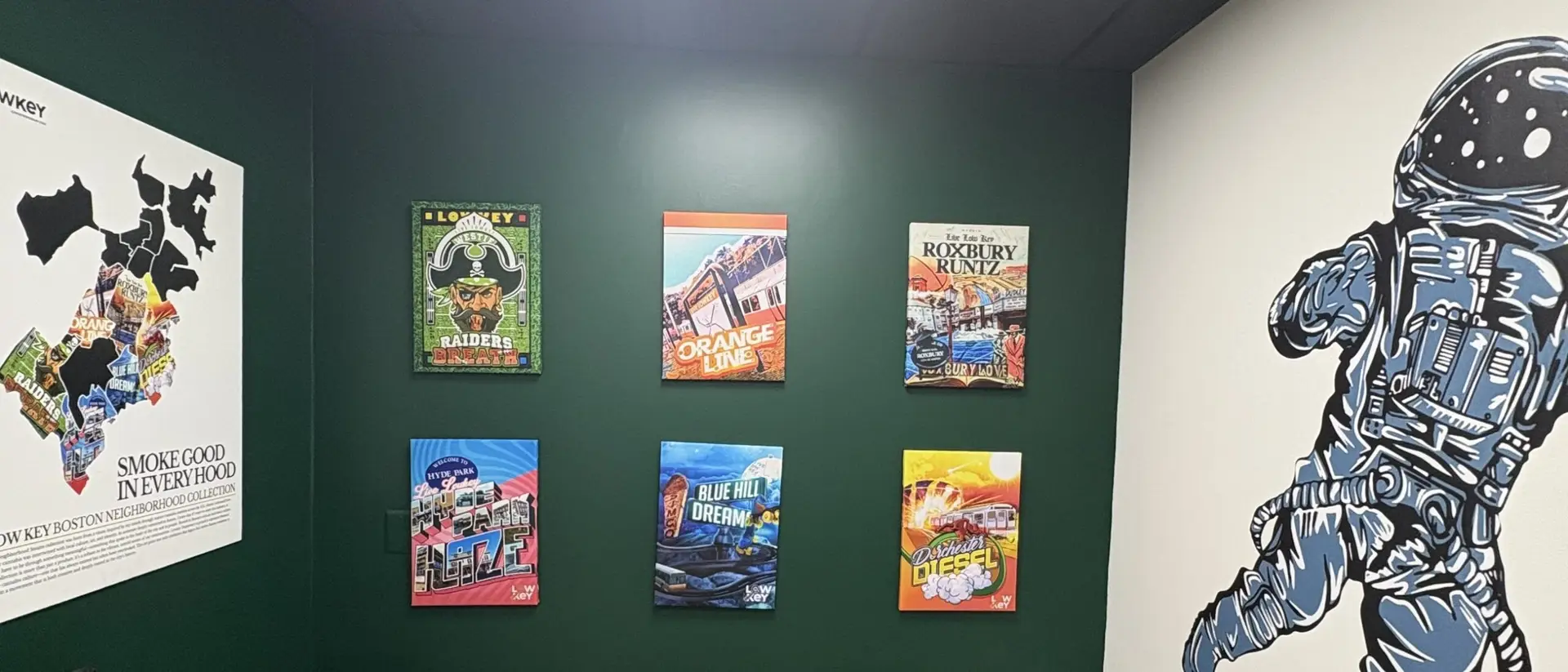 The Lowkey lounge - the Boston neighborhood map beside six commissioned strain canvases